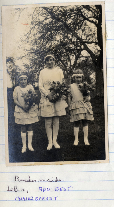 Three young bridesmaids holding flower bouquets