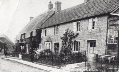 Sunnyside cottages and shop with people.